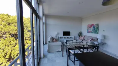 a living room with a table and a couch at APARTAMENTOS MINA4 tipo I in Cádiz