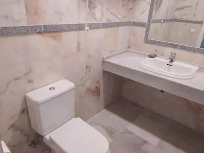 a bathroom with a white toilet and a sink at APARTAMENTOS MINA4 tipo I in Cádiz
