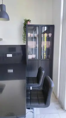 a desk with two chairs next to a book shelf at APARTAMENTOS MINA4 tipo I in Cádiz