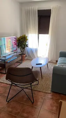 a living room with a couch and a table at Casa trillo in Sanlúcar de Barrameda