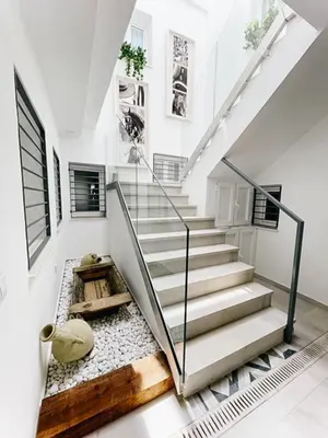 a staircase in a house with white walls and white floors at Eva Recommends Capilla de la Jura en Jerez in Jerez de la Frontera