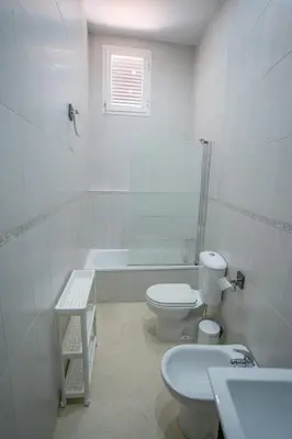 a bathroom with a toilet and a tub and a sink at Las Palomas 15 in Sanlúcar de Barrameda