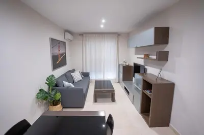 a living room with a couch and a table at Las Palomas 15 in Sanlúcar de Barrameda