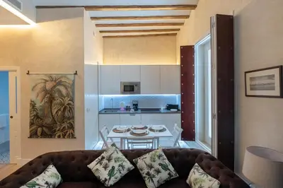 a living room with a couch and a table at Gadir Suites in Cádiz