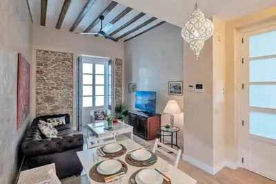 a living room with a couch and a table at Gadir Suites in Cádiz