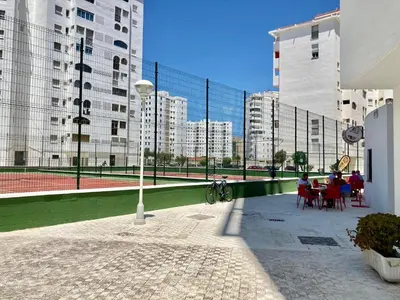 a group of people sitting at tables on a tennis court at ESTUDIO BLEGAMAR TERRAZA - Playa, WiFi y Aparcamiento in El Puerto de Santa María