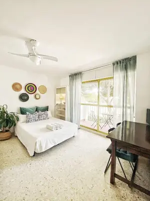 a bedroom with a bed and a desk and a window at ESTUDIO BLEGAMAR TERRAZA - Playa, WiFi y Aparcamiento in El Puerto de Santa María