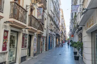 a street in a city with people walking down the street at Apartment La Gitanilla terrace in Cádiz