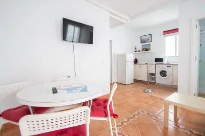 a living room with a white table and chairs at Apartment La Gitanilla terrace in Cádiz