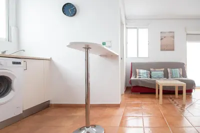 a living room with a washing machine and a couch at Apartment La Gitanilla terrace in Cádiz