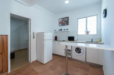 a kitchen with a refrigerator and a washer and dryer at Apartment La Gitanilla terrace in Cádiz