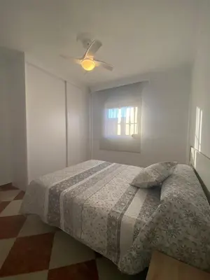 a bedroom with a bed and a ceiling fan at Casa Silvia in Cádiz