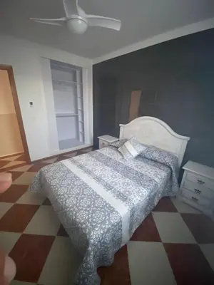 a bedroom with a bed and a ceiling fan at Casa Silvia in Cádiz