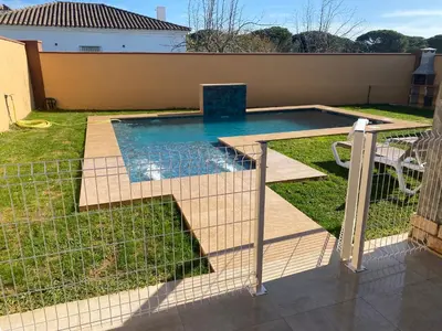 a small swimming pool in a yard with a fence at Casa Silvia in Cádiz