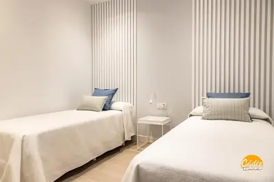 two beds sitting next to each other in a room at Villalobos by Cadiz Time in Cádiz