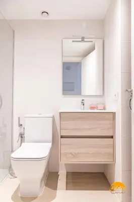 a bathroom with a toilet and a sink and a mirror at Villalobos by Cadiz Time in Cádiz