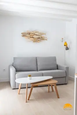 a living room with a couch and a coffee table at Villalobos by Cadiz Time in Cádiz