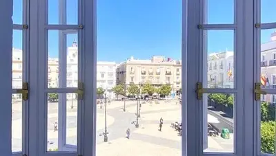 a view of a city from an open window at innCádizPalacio Conde Casa-Brunet in Cádiz
