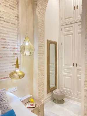 a bedroom with a bed and a mirror at innCádizPalacio Conde Casa-Brunet in Cádiz