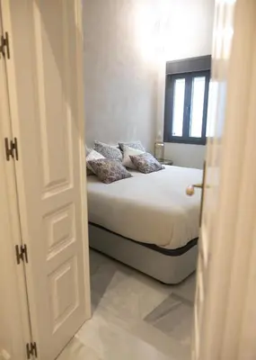 a bedroom with a bed and a window at innCádizPalacio Conde Casa-Brunet in Cádiz