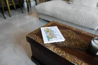 a coffee table with a picture on it in a living room at innCádizPalacio Conde Casa-Brunet in Cádiz