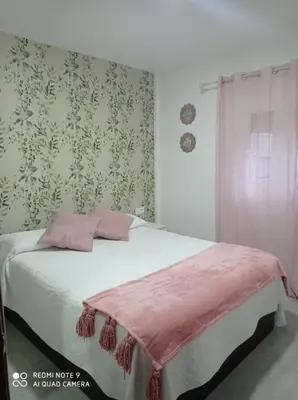 a bedroom with a bed with a pink blanket on it at Love & Dream Beach Grupo AC Gestion in Cádiz