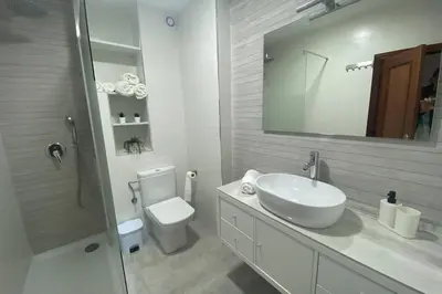 a bathroom with a sink and a toilet and a mirror at Love & Dream Beach Grupo AC Gestion in Cádiz