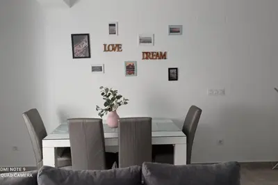 a dining room table and chairs with pictures on the wall at Love & Dream Beach Grupo AC Gestion in Cádiz