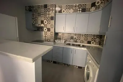 a kitchen with white cabinets and a washing machine in it at Love & Dream Beach Grupo AC Gestion in Cádiz