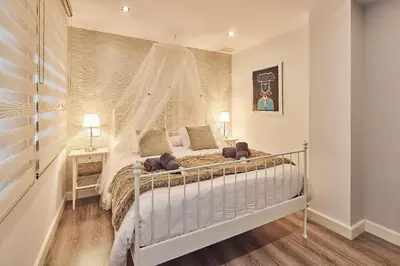 a bedroom with a bed with a canopy at La Casa de Carmen Centro Historico , Free Parking in Cádiz
