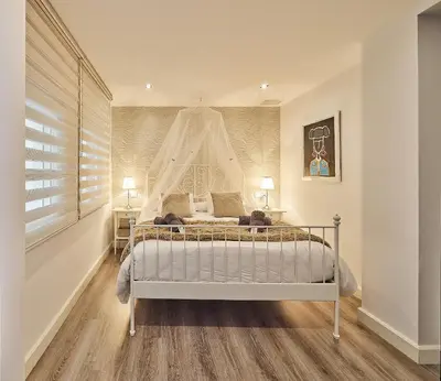 a bedroom with a white bed and a window at La Casa de Carmen Centro Historico , Free Parking in Cádiz