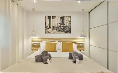 a bedroom with a large bed with two brown pillows at La Casa de Carmen Centro Historico , Free Parking in Cádiz