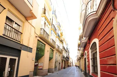 an alley between two buildings in a city at La Casa de Carmen Centro Historico , Free Parking in Cádiz