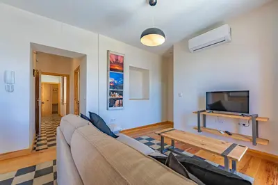 a living room with a couch and a tv at New Use Pz España in Cádiz