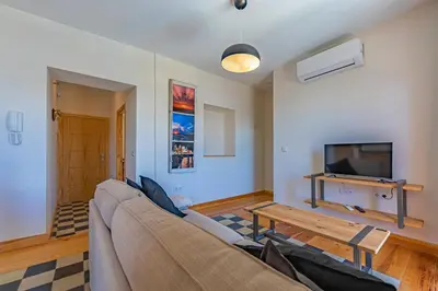 a living room with a couch and a tv at New Use Pz España in Cádiz