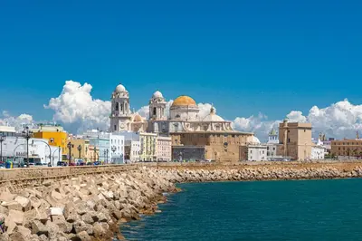 a group of buildings next to the water at New Use Pz España in Cádiz