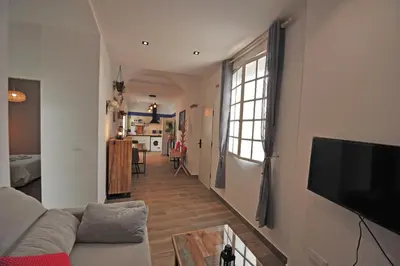 a living room with a couch and a tv at Original Céntrico Bohemio in Jerez de la Frontera