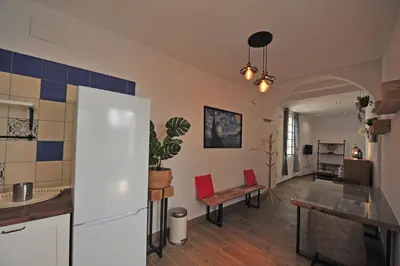 a kitchen and living room with a white refrigerator at Original Céntrico Bohemio in Jerez de la Frontera