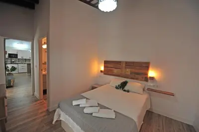 a bedroom with a large bed with towels on it at Original Céntrico Bohemio in Jerez de la Frontera