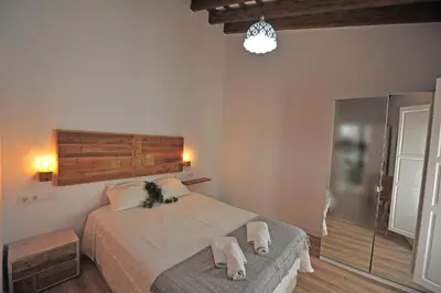 a bedroom with a bed with two towels on it at Original Céntrico Bohemio in Jerez de la Frontera