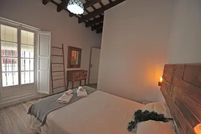 a bedroom with a bed with two towels on it at Original Céntrico Bohemio in Jerez de la Frontera