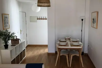 a dining room with a wooden table and chairs at ÁTICO EN EL CENTRO, terraza 20 m2, garaje, Wi-Fi, AC in Sanlúcar de Barrameda