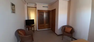 a living room with two chairs and a television at Apartamento S. Fernando bahia sur in San Fernando