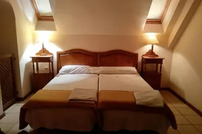 a bedroom with a bed with two lamps on both sides at Apartamento S. Fernando bahia sur in San Fernando