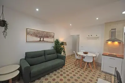 a living room with a couch and a table at Palacete Centro Duque de Valais in Jerez de la Frontera