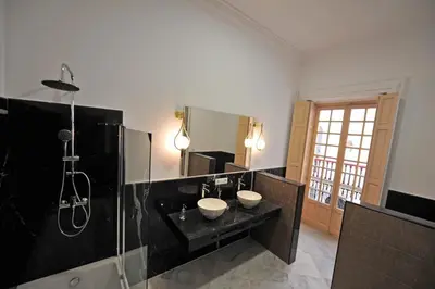 a bathroom with two sinks and a shower at Palacete Centro Duque de Valais in Jerez de la Frontera