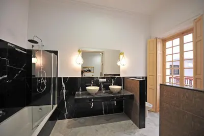 a bathroom with two sinks and a mirror at Palacete Centro Duque de Valais in Jerez de la Frontera