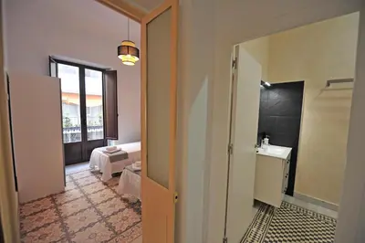 a room with a bathroom with a sink and a bed at Palacete Centro Duque de Valais in Jerez de la Frontera