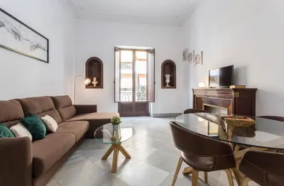 a living room with a couch and a table at Palacete Centro Duque de Valais in Jerez de la Frontera