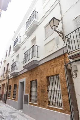 a building with balconies on the side of it at Casa Patio La Viña by Cadiz Time in Cádiz